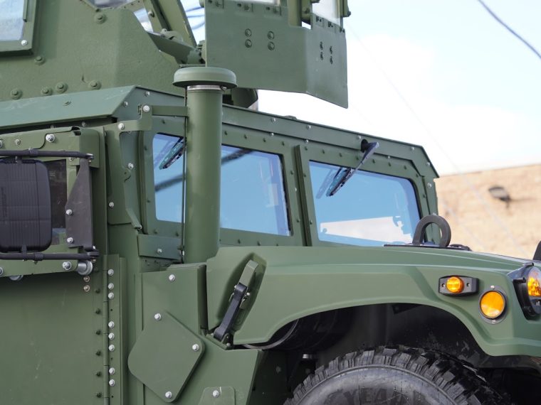 An armored Humvee with an IBIS Tek windshield
